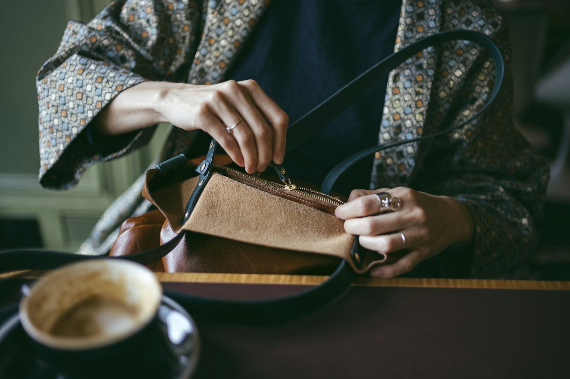 Panoramic shot of the factory workshop production line, workers sewing leather goods, highlighting scale and craftsmanship